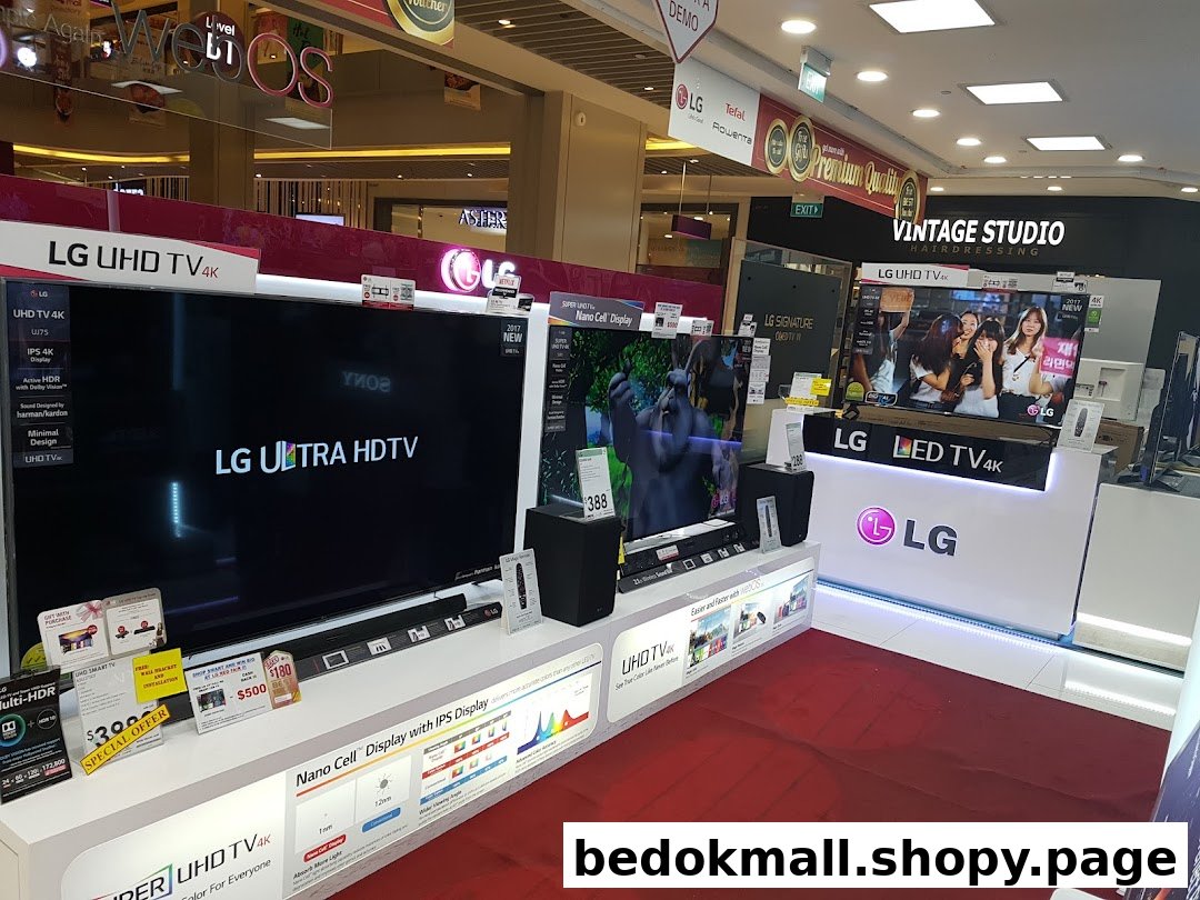 Interior view of an electronics store displaying LG televisions and other products.