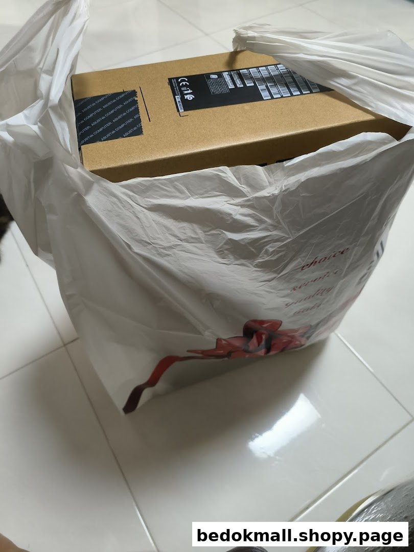 A brown product box is inside a white plastic shopping bag.