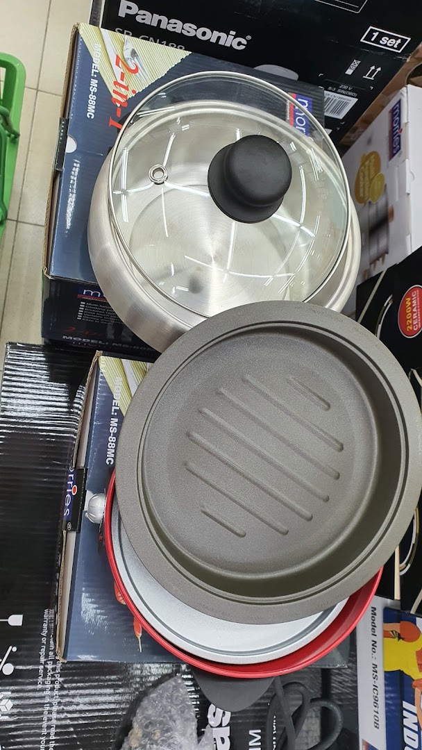 Kitchen appliances, including a pot and grill pan, displayed on boxes.