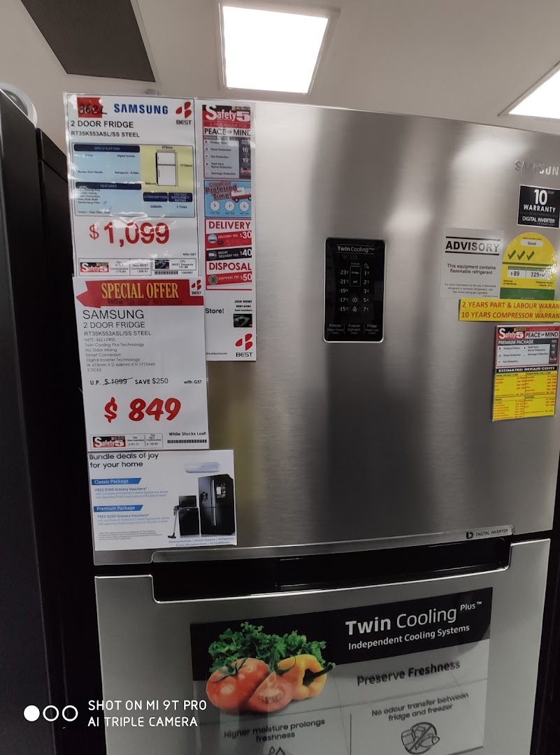 A silver Samsung refrigerator with price tags and product information on display.