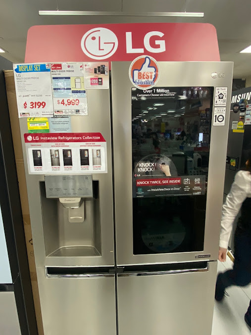 An LG multi-door refrigerator on display in an electronics store.