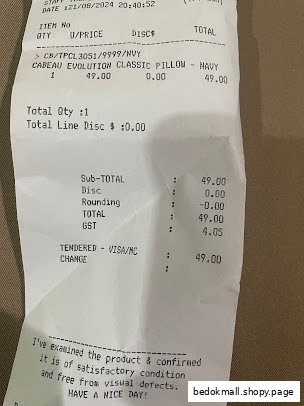 Close-up of a retail sales receipt for a pillow, showing price and details.