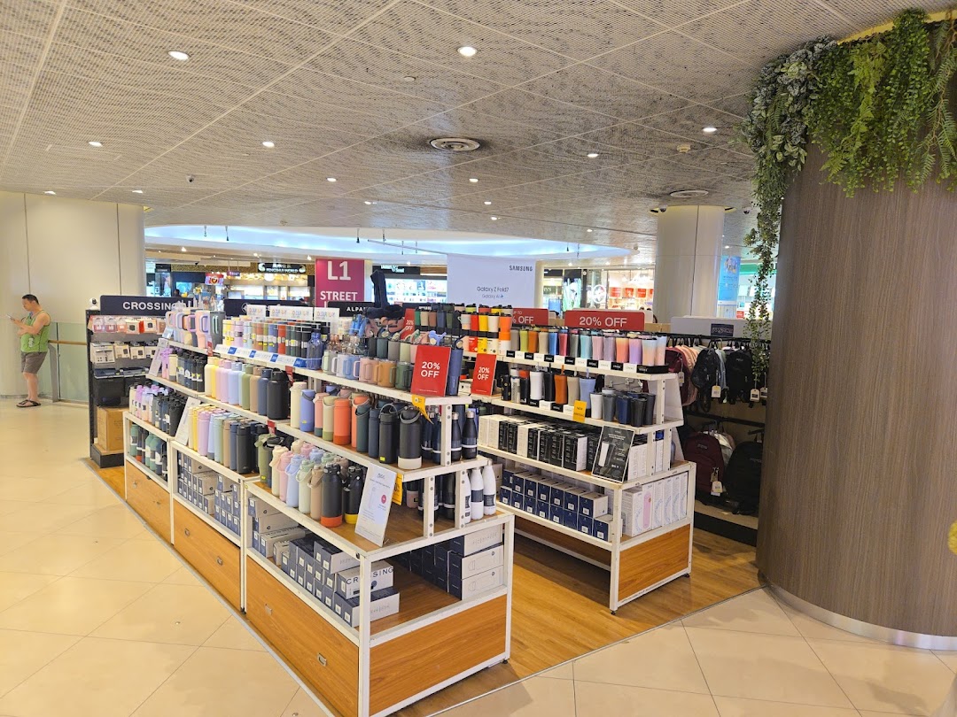 Interior view of a shop displaying various bottles and bags on shelves.