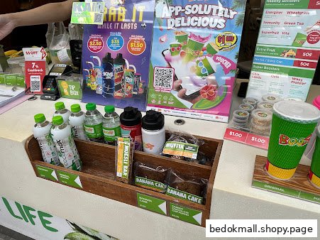 Counter with drinks, snacks, and promotional posters at Boost Juice.