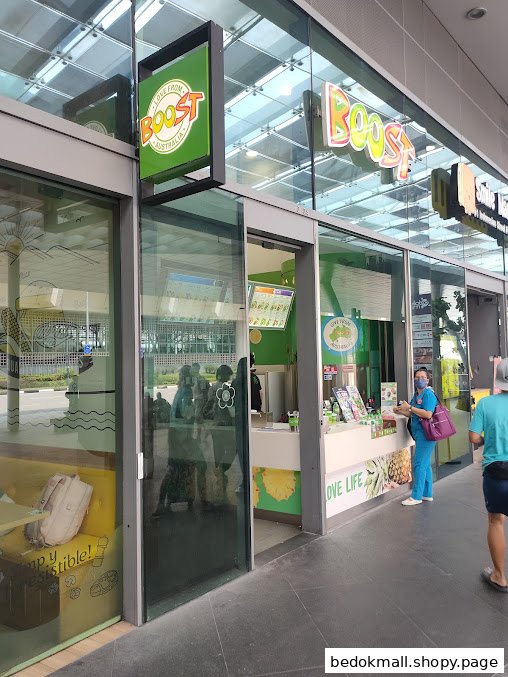 Exterior view of Boost Juice shop with glass facade and signage.