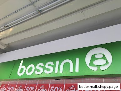 Bossini shop sign with logo and sale banners.