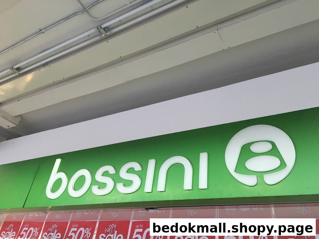 Close-up of Bossini shop sign with sale banners displayed below.