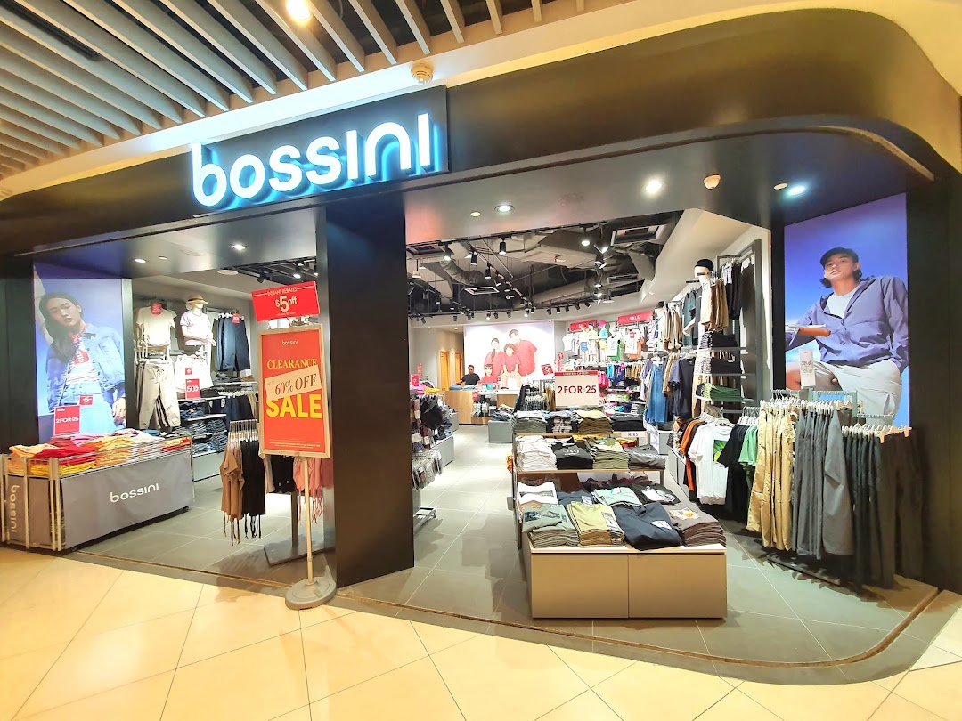 Front view of a Bossini clothing store with visible displays and sale signs.