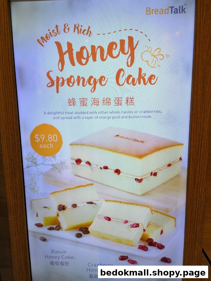 A display board advertising Honey Sponge Cake with price and variations.