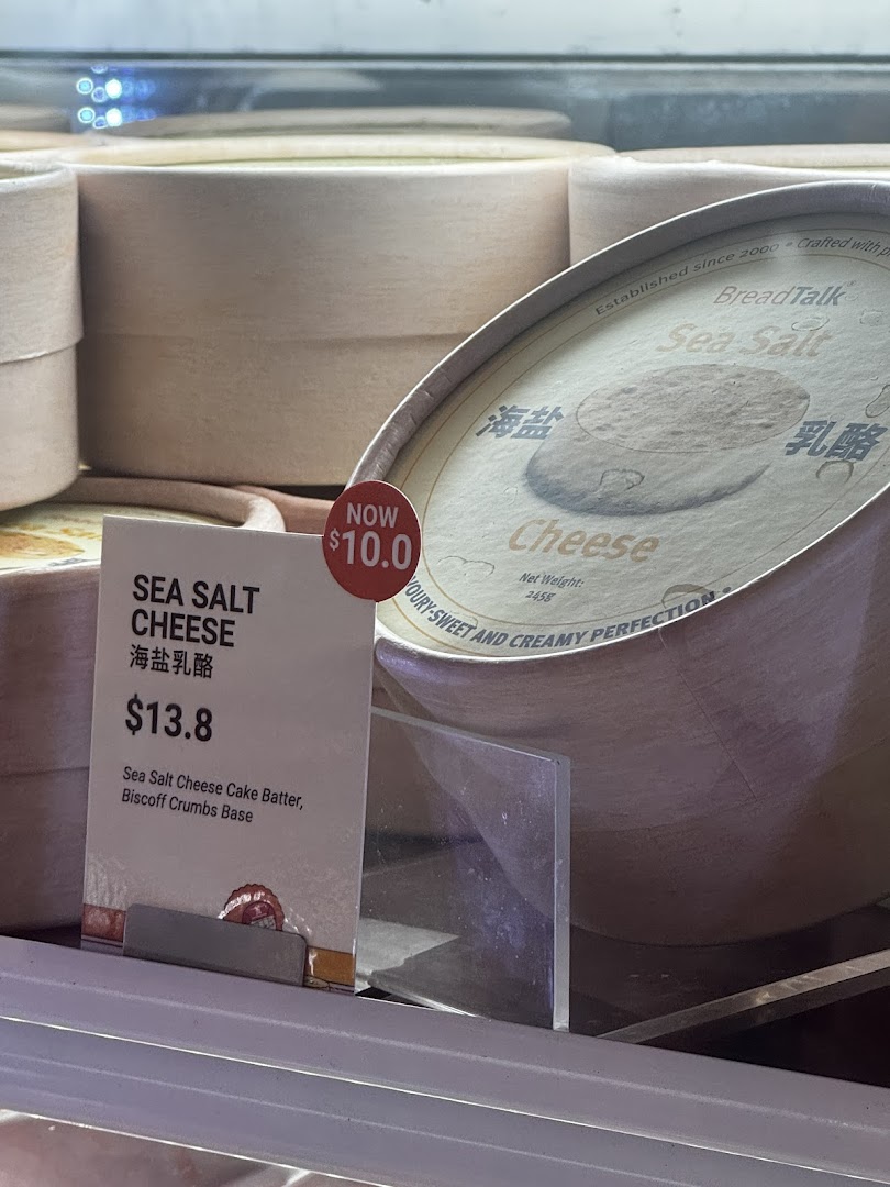 Sea Salt Cheese cake with price tag displayed in a refrigerated case.