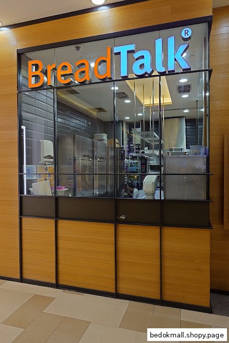 Exterior view of a BreadTalk shop with glass front and prominent signage.