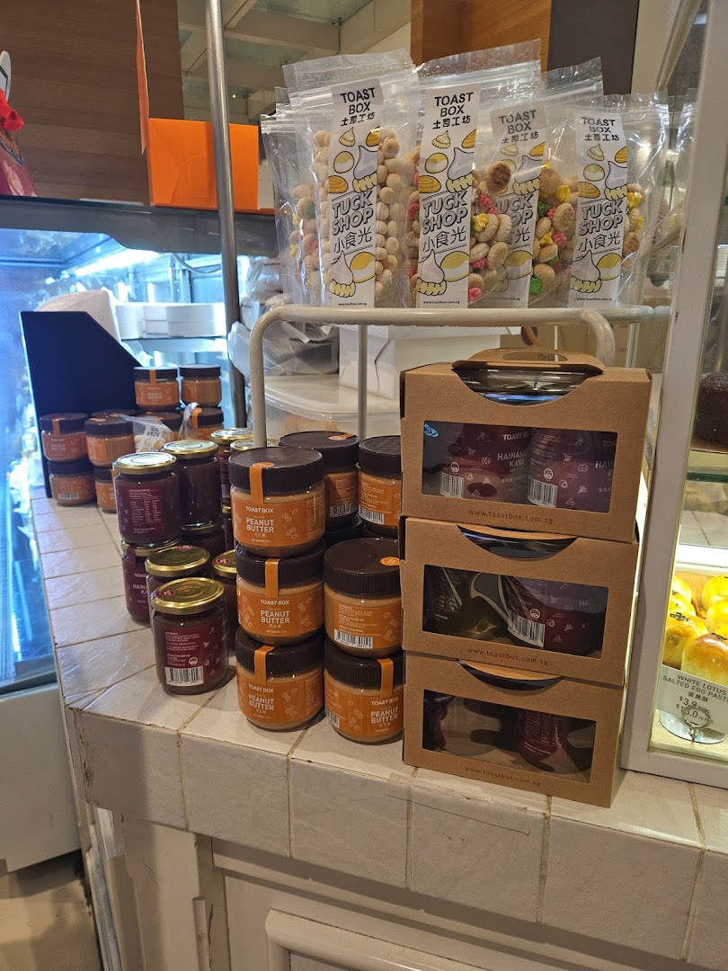 Various packaged snacks and jars of spreads displayed on a shop counter.