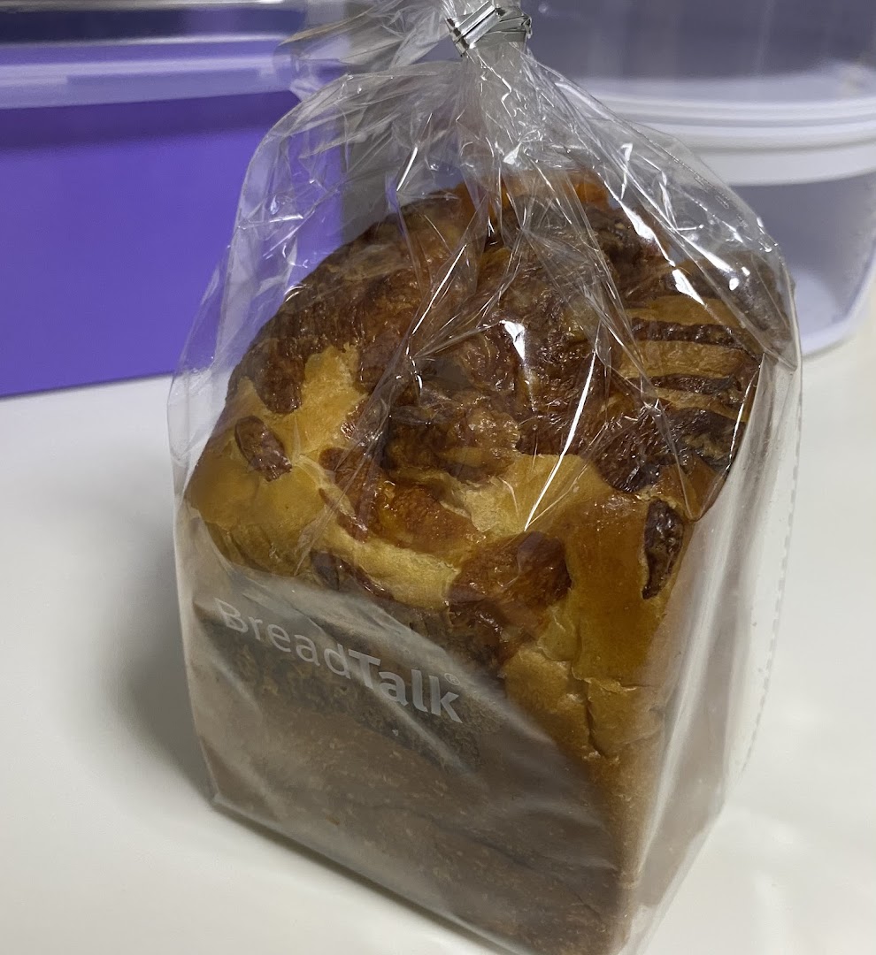 Close-up of a BreadTalk bread loaf in a clear plastic bag.