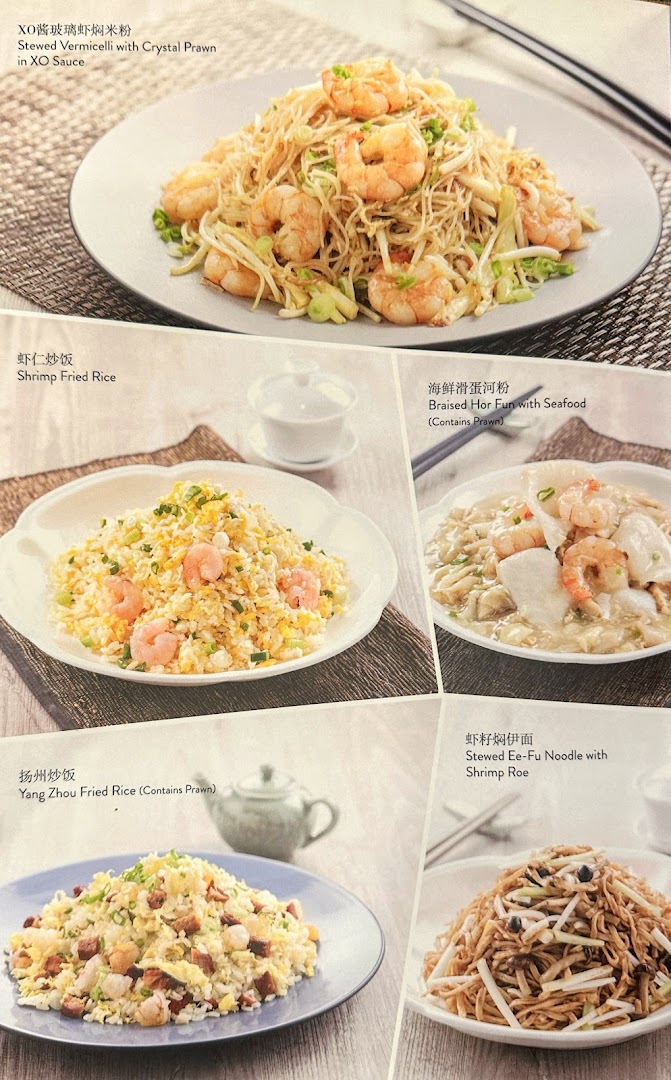 Close-up of a restaurant menu displaying various noodle and rice dishes.