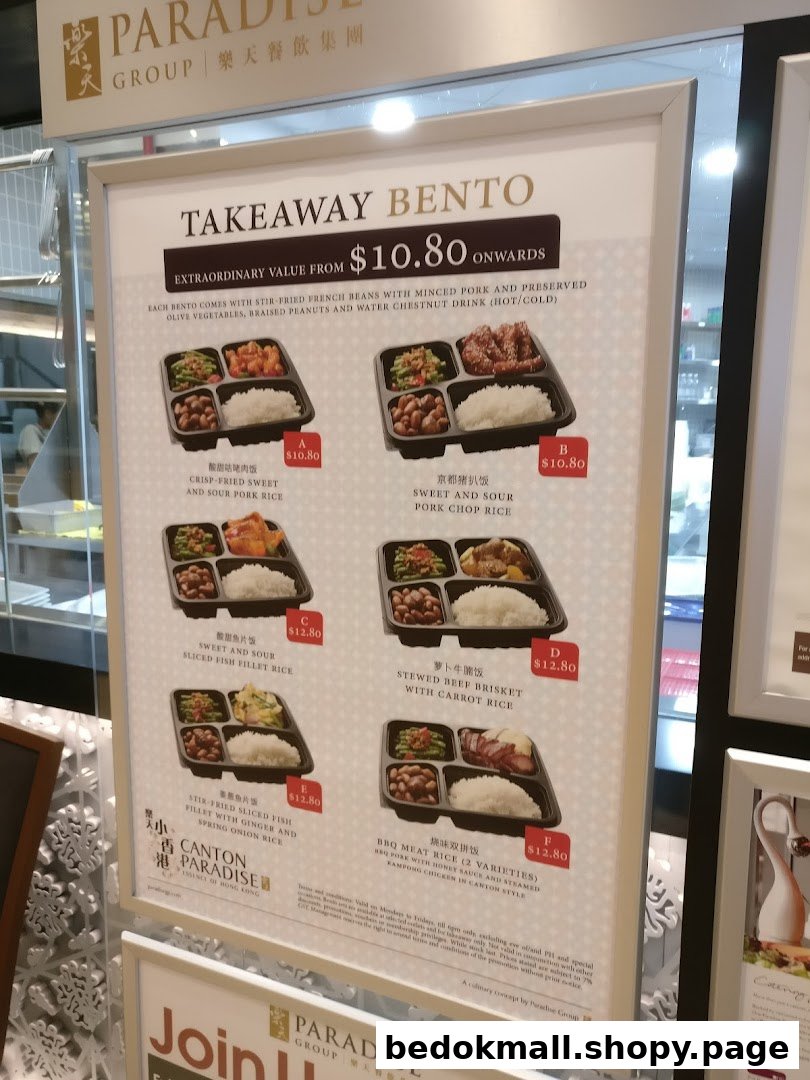 A display board showing various takeaway bento options with prices.