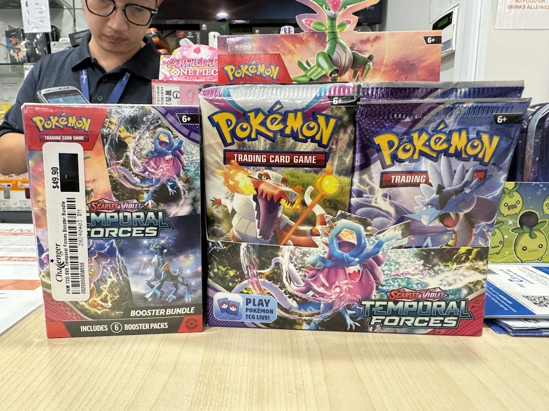 Pokémon trading card game products displayed on a counter in a shop.