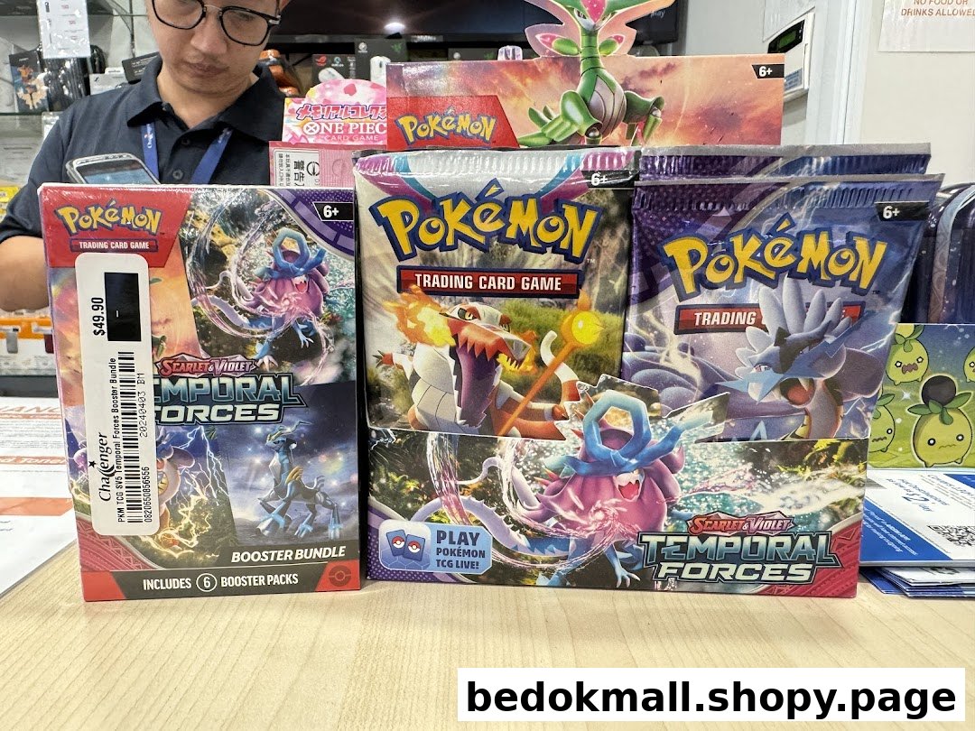 Pokémon trading card game products displayed on a counter in a shop.
