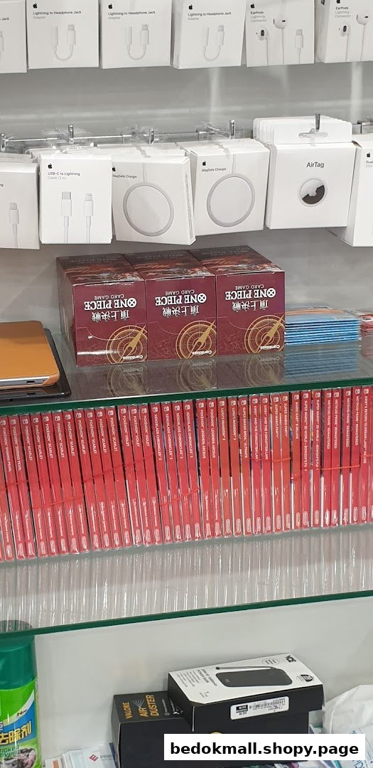 Shelves displaying Apple accessories, One Piece card games, and Nintendo Switch games.