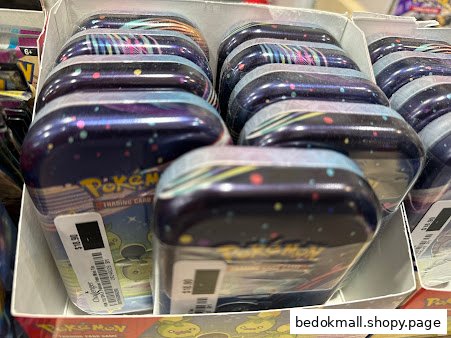 Close-up of multiple Pokemon Trading Card tins displayed for sale.