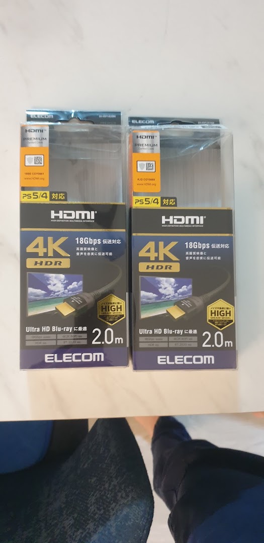 Two packaged HDMI cables are displayed on a surface.