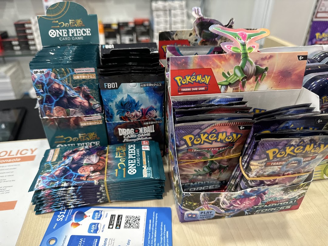 Display of One Piece, Dragon Ball, and Pokemon trading card game packs.