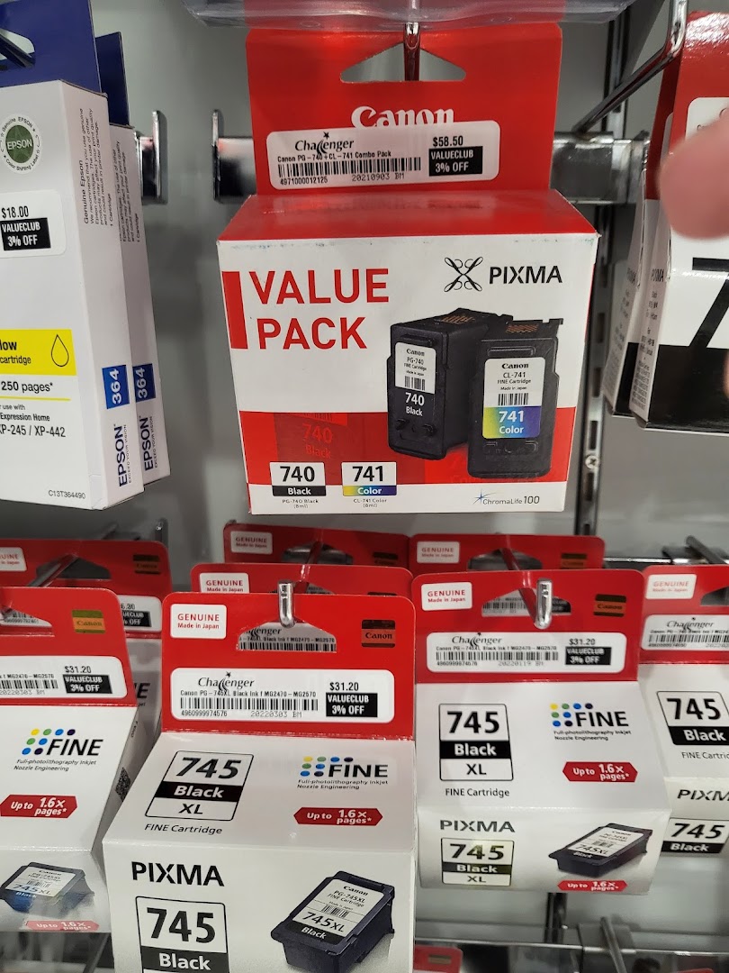 Shelves displaying various brands of ink cartridges for sale in a retail store.