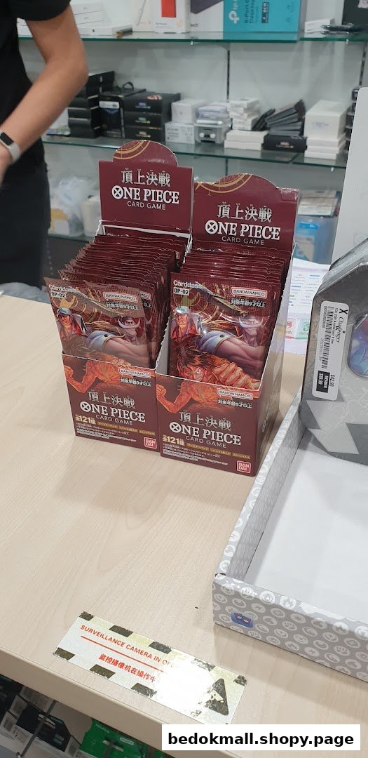 Display of One Piece Card Game booster packs on a shop counter.
