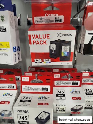 Close-up of printer ink cartridges displayed on shelves in a retail store.