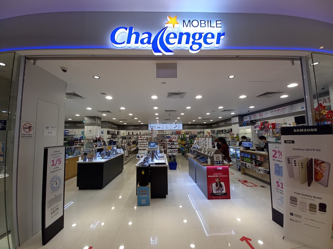 View into a Challenger electronics store from its entrance, showing products and staff.
