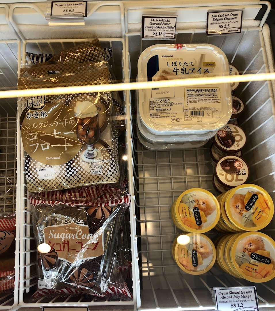 Freezer display case filled with various packaged ice cream and desserts.
