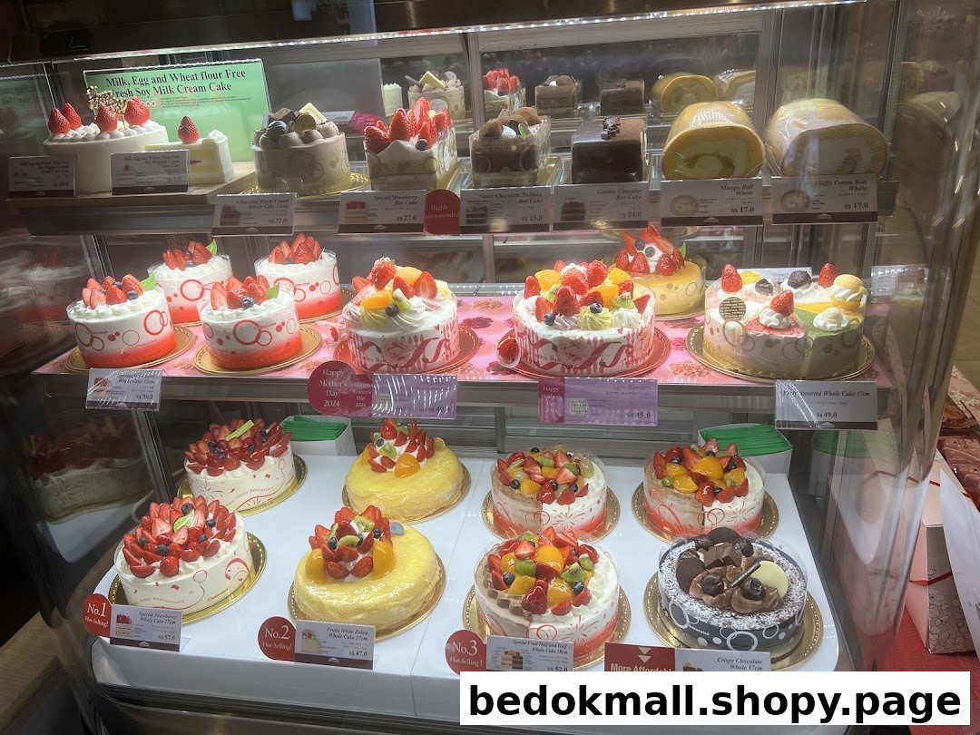 A display case filled with various cakes and pastries.