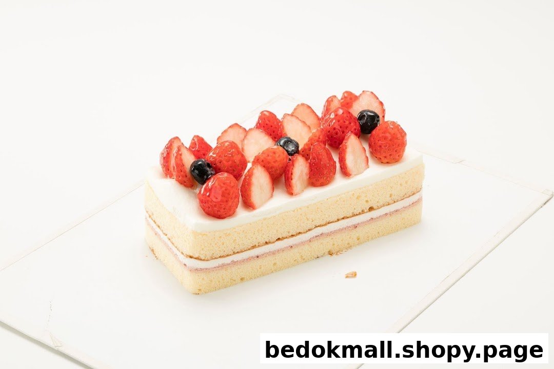 A rectangular cake topped with fresh strawberries and blueberries on a white background.