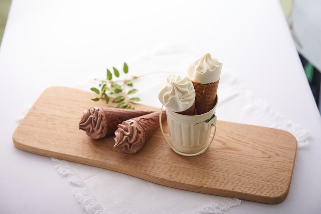 Ice cream cones, chocolate and vanilla, on a wooden board.