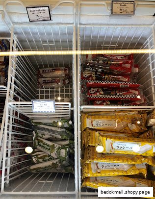 Freezer display case filled with various packaged frozen desserts and ice cream bars.