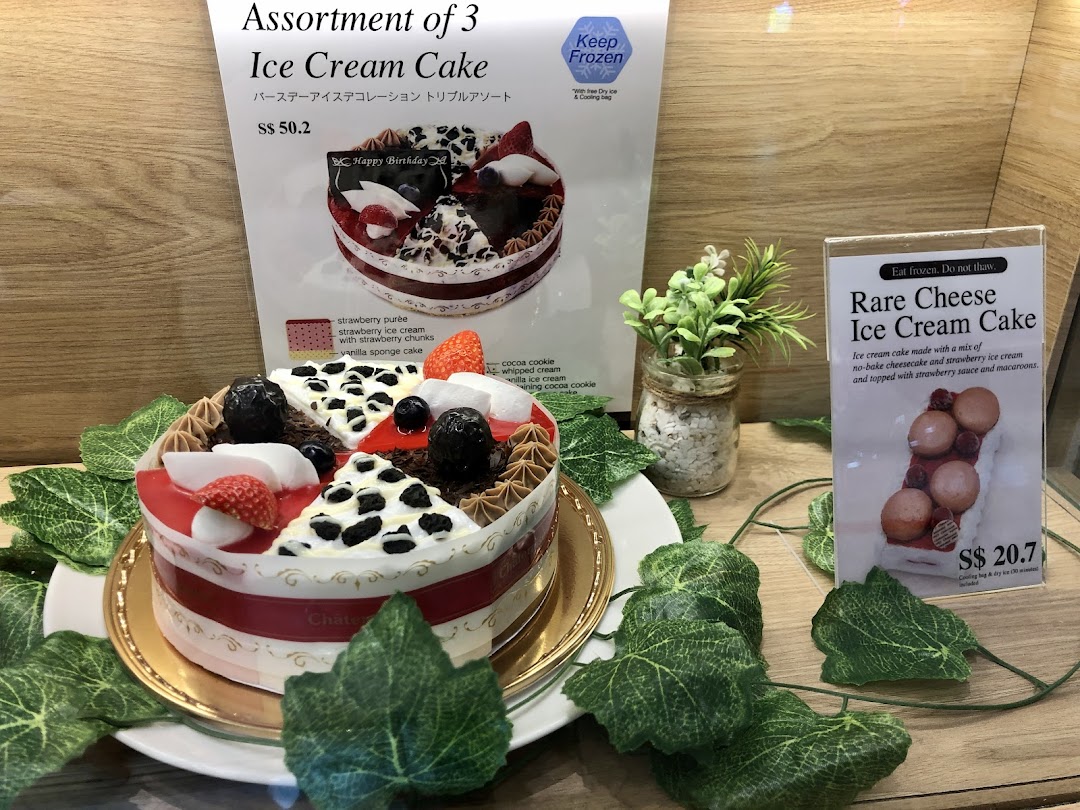 A display of ice cream cakes with accompanying menu signs and prices.
