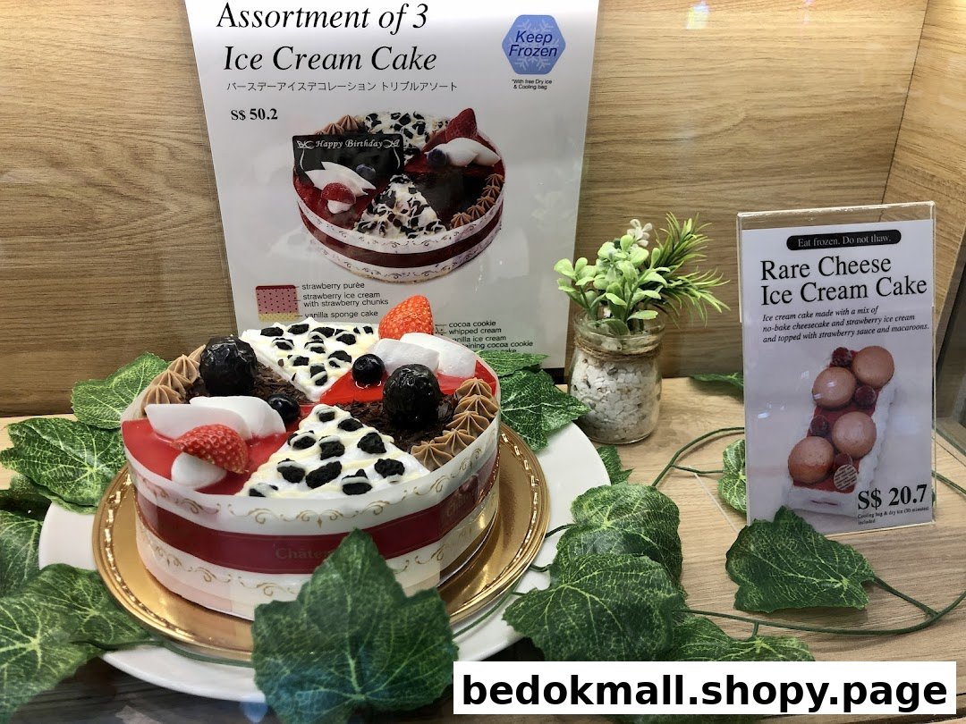 A display of ice cream cakes with accompanying menu signs and prices.