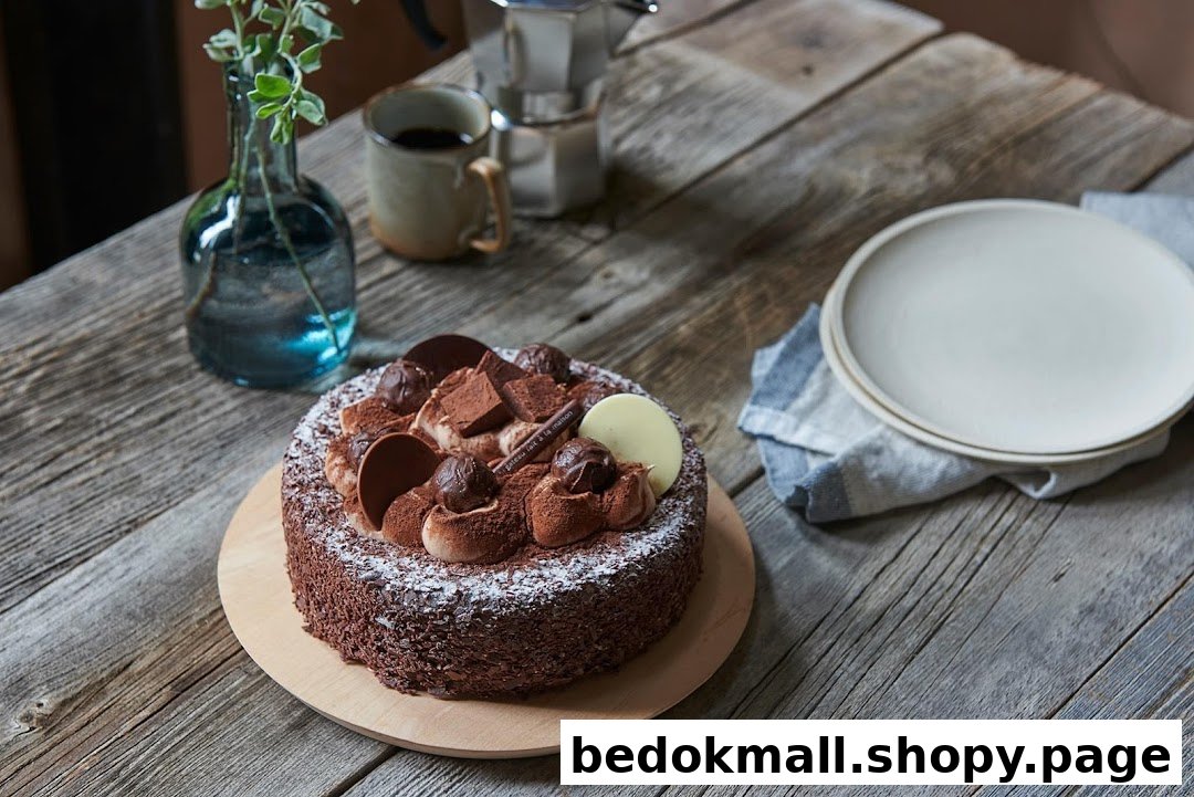A chocolate cake on a rustic wooden table with coffee and plates.