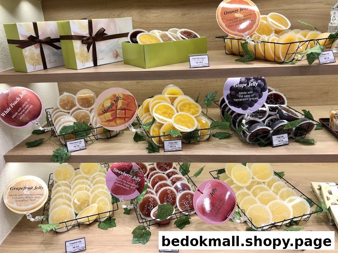 Display of various fruit jellies and gift boxes on shelves.
