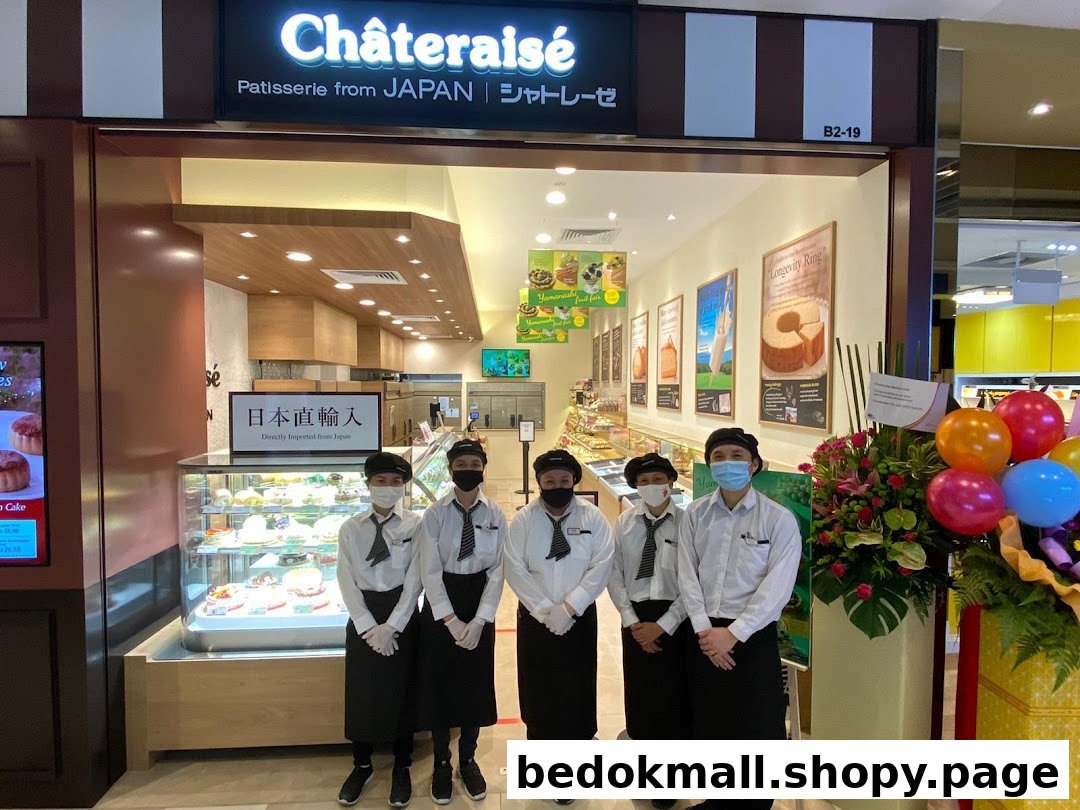 Châteraisé shop front with staff members and opening decorations.