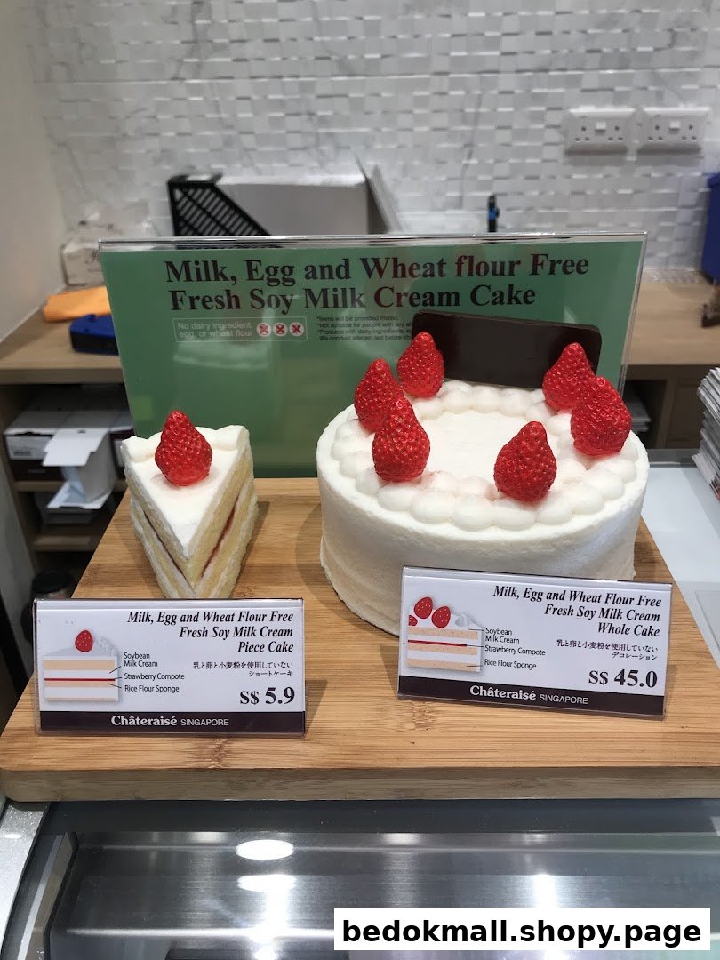 Cakes and their price tags displayed on a wooden board.