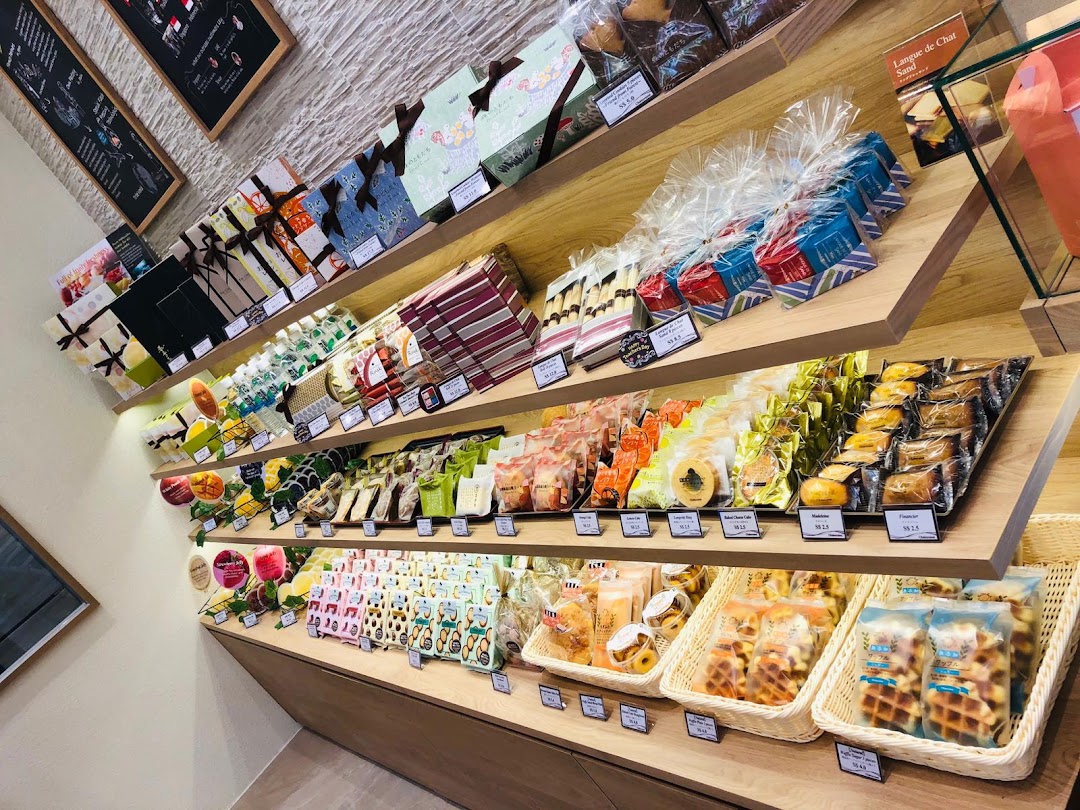 Shelves displaying various packaged pastries and snacks inside a shop.