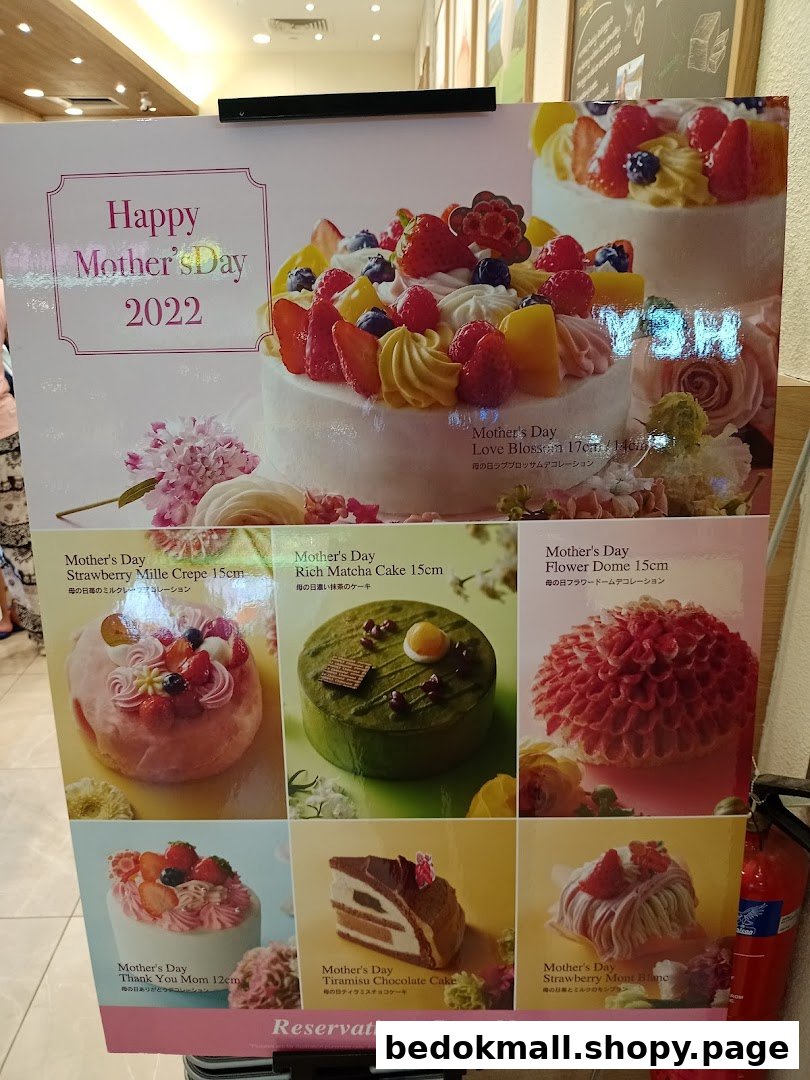 A display board showcasing various Mother's Day cakes with descriptions and prices.