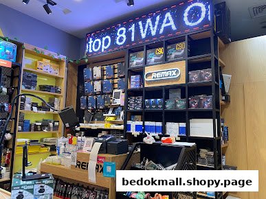 Interior view of an electronics and accessories shop with shelves and products.