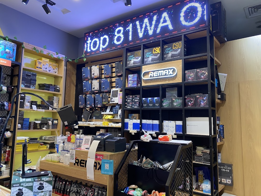 Interior view of an electronics shop with shelves of products and a counter.