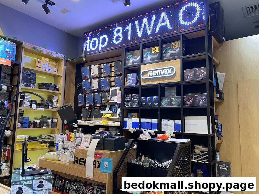 Interior view of an electronics shop with shelves of products and a counter.