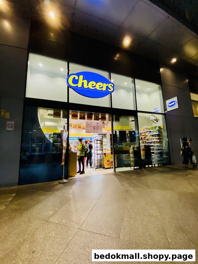 Exterior view of a brightly lit Cheers convenience store entrance at night.