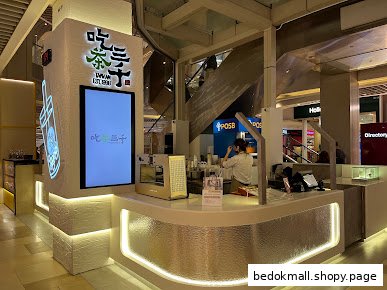 Interior view of a bubble tea shop counter with staff preparing drinks.