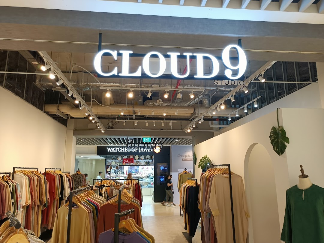 Interior view of Cloud 9 Studio with clothing racks and merchandise.