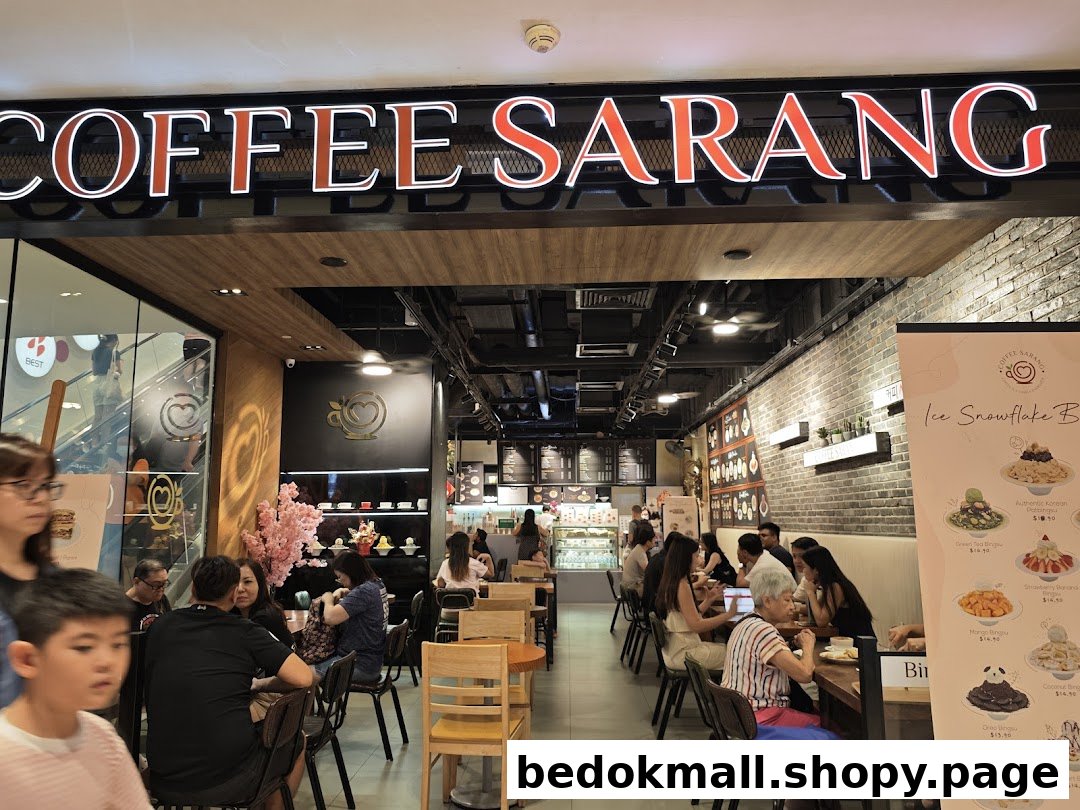 Interior view of a busy coffee shop with customers seated at tables.