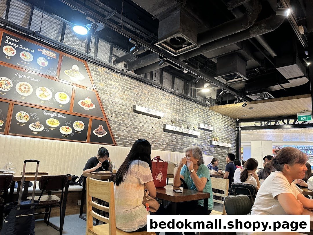 Customers enjoy treats at COFFEESARANG, featuring a prominent menu board with waffles, sandwiches, and croffles.